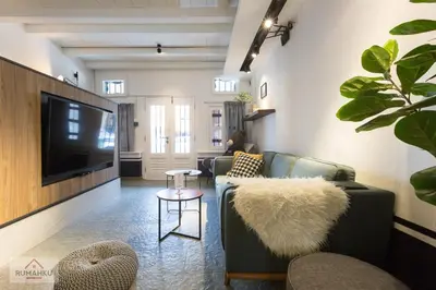 a living room with a couch and a tv at RumahKu Georgetown in George Town
