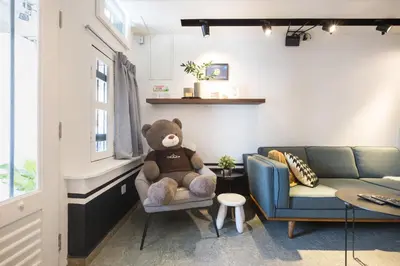 a teddy bear sitting in a chair in a living room at RumahKu Georgetown in George Town