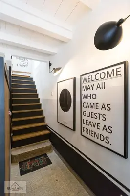 a hallway with stairs and a sign on the wall at RumahKu Georgetown in George Town