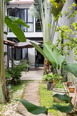 a garden with many plants and a building at RumahKu Georgetown in George Town