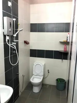 a bathroom with a toilet and a sink and a shower at D’House in Ipoh