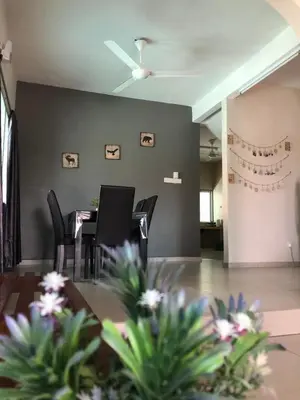 a dining room with black chairs and a table at D’House in Ipoh
