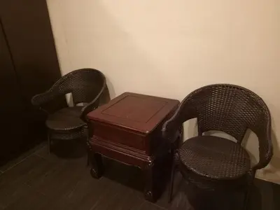 two chairs and a wooden table in a room at Hotel Sri Bernam in Sabak Bernam