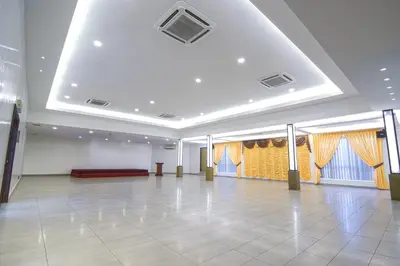 a large room with a dance floor and windows at Hotel Sri Bernam in Sabak Bernam