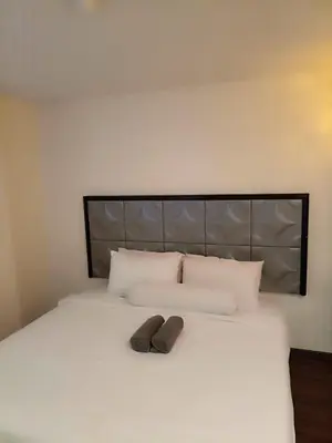 a bed with a pair of shoes sitting on it at M Season Boutique Hotel Sdn Bhd in Sungai Petani
