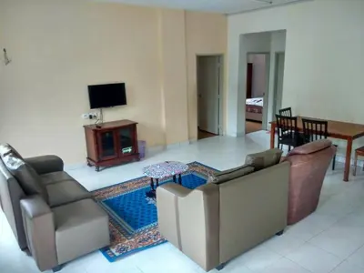 a living room with two couches and a television at Bzout rents in Cameron Highlands