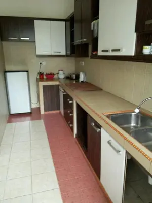 a kitchen with a sink and a refrigerator at Bzout rents in Cameron Highlands