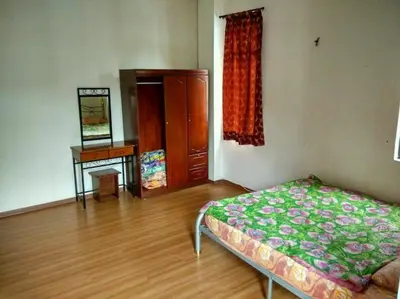 a bedroom with a bed and a dresser and a desk at Bzout rents in Cameron Highlands