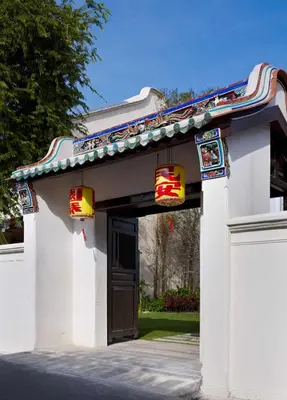 a white building with a gate and a door at 23 Love Lane Hotel in George Town