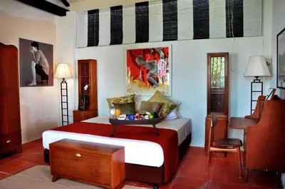 a bedroom with a bed and a desk in it at 23 Love Lane Hotel in George Town