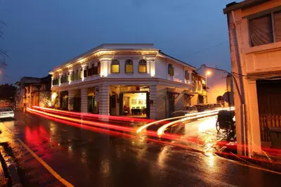 a city street with a building with lights on it at Coffee Atelier in George Town