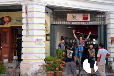 a group of people standing outside of a building at Coffee Atelier in George Town