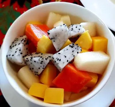 a bowl of fruit and vegetables on a table at Coffee Atelier in George Town