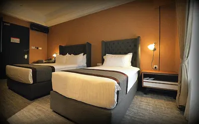 a hotel room with two beds in a room at 1969 Business Suites Bandar Botani, Ipoh in Ipoh
