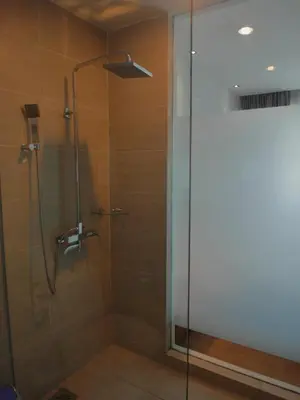 a shower with a glass door in a bathroom at French Hotel in Ipoh
