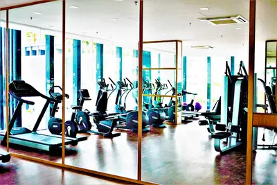 a gym with a lot of treadmills and ellipticals at The Landmark by Katana in George Town