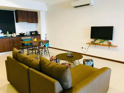 a living room with a couch and a flat screen tv at The Landmark by Katana in George Town