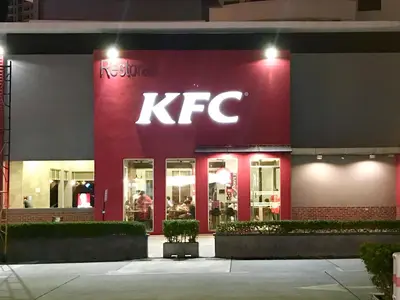a kfc store with a red facade at night at The Landmark by Katana in George Town