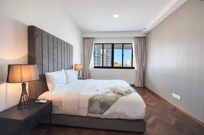 a bedroom with a large bed and a window at The Landmark by Katana in George Town