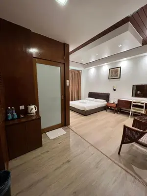 a large room with a bed and a couch and a table at D Eastern Hotel in Ipoh