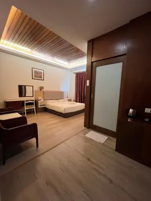 a hotel room with a bed and a sliding glass door at D Eastern Hotel in Ipoh