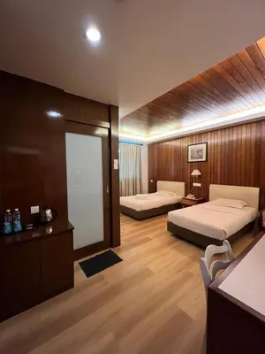a hotel room with two beds and a desk at D Eastern Hotel in Ipoh
