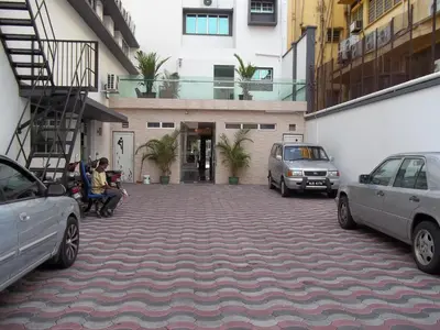 a parking lot with cars parked in front of a building at D Eastern Hotel in Ipoh