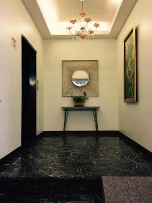 a hallway with a table and a chandelier at D Eastern Hotel in Ipoh