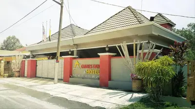 a building with a sign on the side of it at Weng Kong Homestay in Slim River