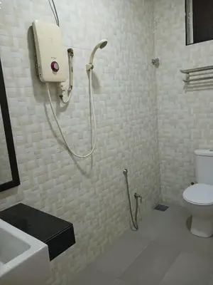 a bathroom with a shower with a toilet and a sink at Weng Kong Homestay in Slim River