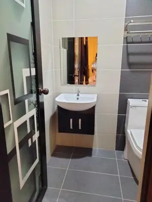 a bathroom with a sink and a toilet at Weng Kong Homestay in Slim River