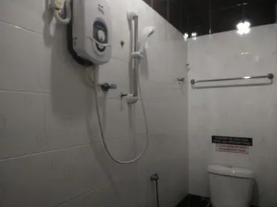 a shower in a bathroom with a toilet at Weng Kong Homestay in Slim River