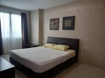 a bedroom with a large bed with two pillows on it at K. Riverfront apartment in Ipoh