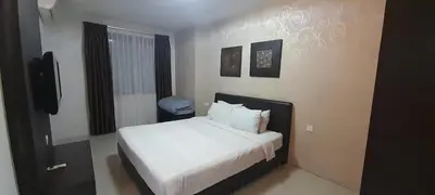 a bedroom with a bed with white sheets and pillows at K. Riverfront apartment in Ipoh