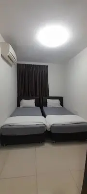 two twin beds in a room with a window at K. Riverfront apartment in Ipoh