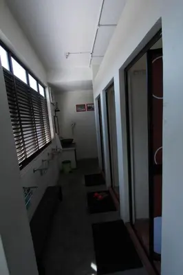 a room with a hallway with windows and a staircase at Red Inn Court in George Town