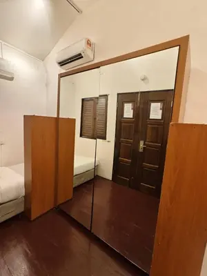 a room with a mirror and a bed and a bed sqor at Red Inn Court in George Town