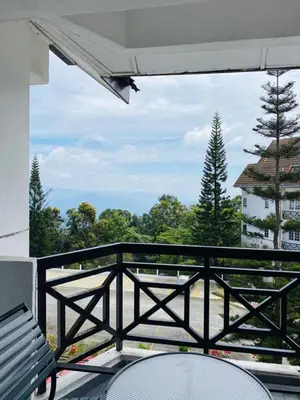 a balcony with a view of a tree at Habitat Fraser's Hill in Bukit Fraser