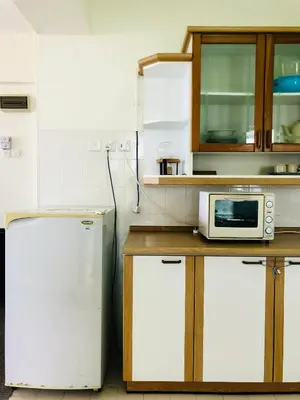 a kitchen with a white refrigerator and a microwave at Habitat Fraser's Hill in Bukit Fraser