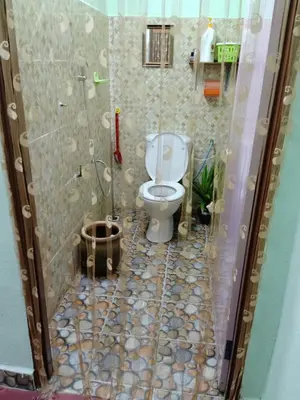 a bathroom with a toilet and a shower at Homestay Damai Sri Kota in Kepala Batas