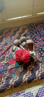 a basket of flowers on top of a rug at Homestay Damai Sri Kota in Kepala Batas