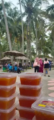 a group of bowls of food on a table with palm trees at Homestay Damai Sri Kota in Kepala Batas