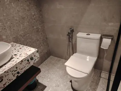 a bathroom with a white toilet and a sink at The Jerai Hotel Sungai Petani in Sungai Petani