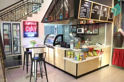 a fast food restaurant with a counter with stools at The Jerai Hotel Sungai Petani in Sungai Petani