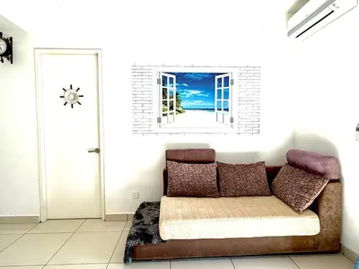 a couch in a living room with a window at HomeSweetHome in Perai