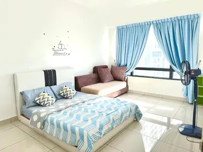 a bedroom with a bed and a couch and a window at HomeSweetHome in Perai