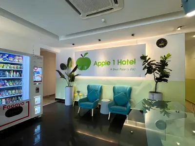 an apple i hotel with blue chairs and a table at Apple 1 Hotel Queensbay in Bayan Lepas