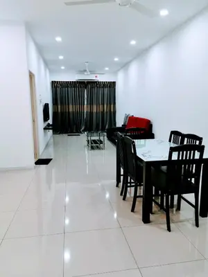 a living room with a table and chairs and a couch at Mr.J Homestay in Taiping