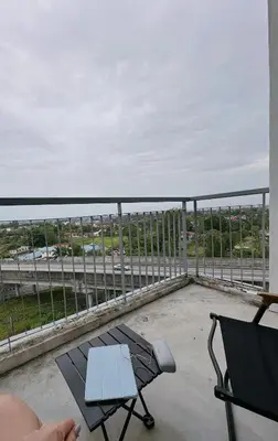 a view of a balcony with a table and a chair at Taiping Centre Point Suite 7 by BWC in Taiping