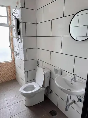a white bathroom with a toilet and a sink at Taiping Centre Point Suite 9 by BWC in Taiping